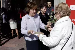 Carmen Caffarel, directora del Instituto Cervantes, entrega a los asistentes una rosa y un libro con motivo de el Día del Libro.